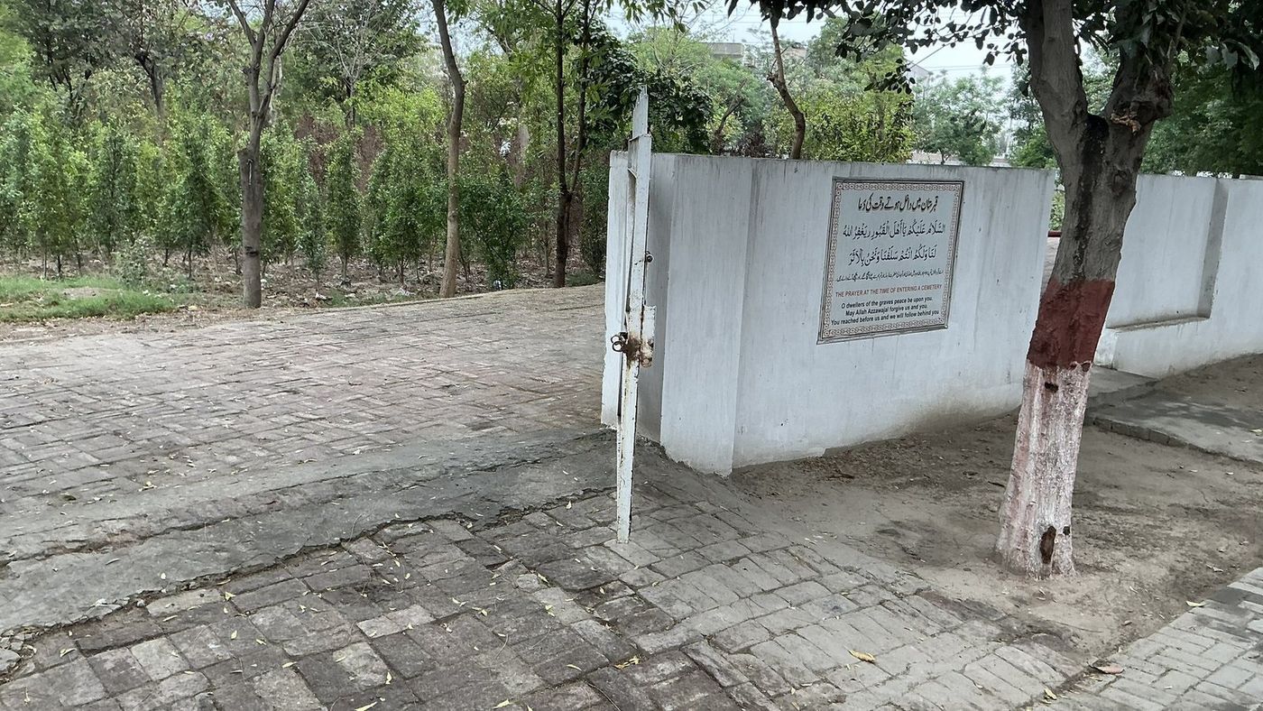 The graveyard gate of Abdalians Cooperative Housing Society with its entry prayer plaque